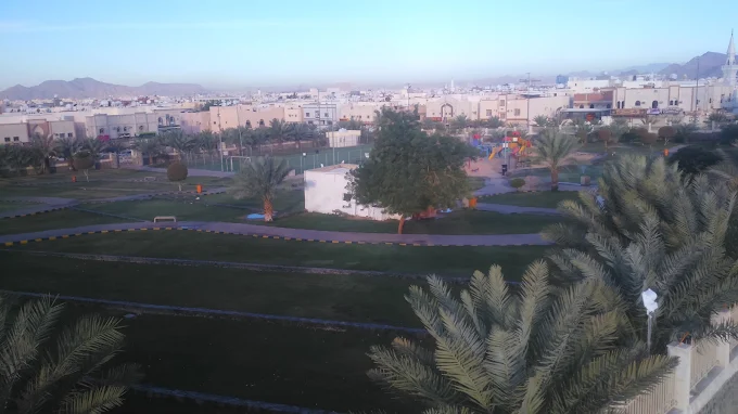 Community park and low-rise residential district in Madinah at first light